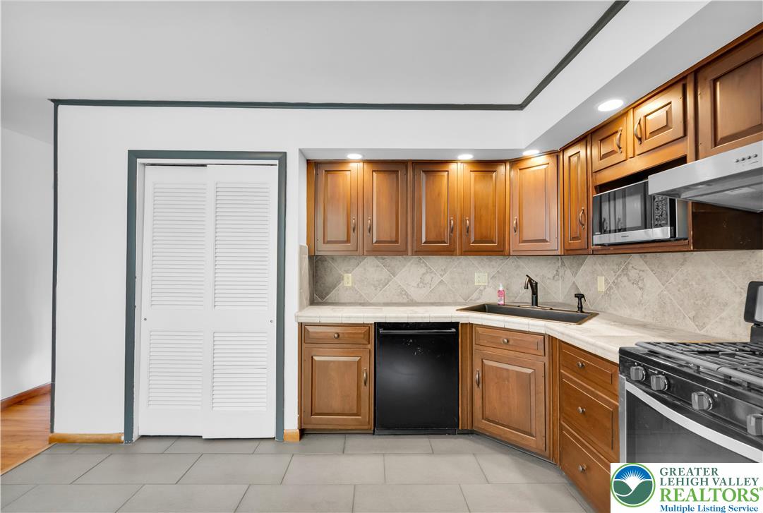 2118 6th Street Bethlehem, PA 18020 - Photo 8 of 40 a kitchen with stainless steel appliances granite countertop a stove and a sink