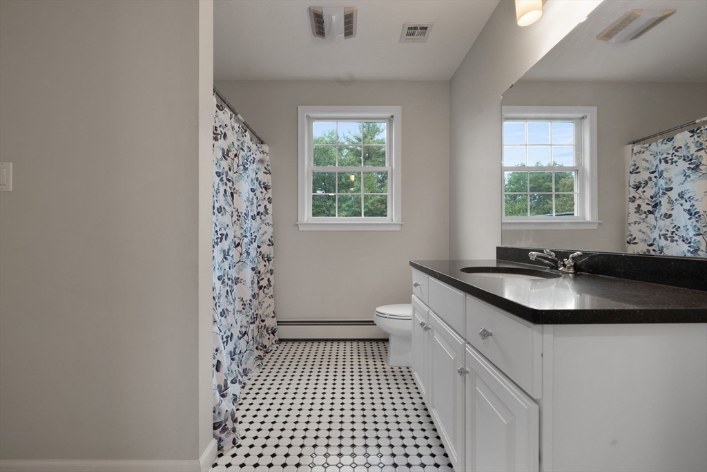 731 Samuel Drive Northbridge, MA 01588 - Photo 21 of 33 a bathroom with a sink a toilet a window and vanity
