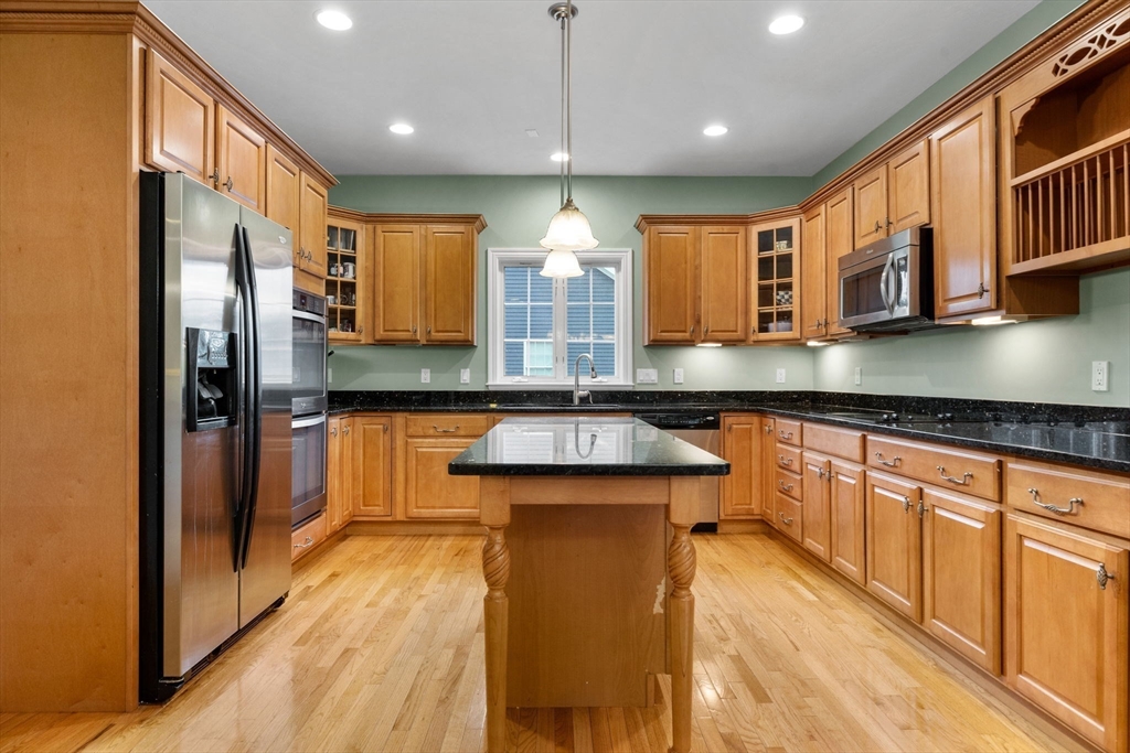 731 Samuel Drive Northbridge, MA 01588 - Photo 4 of 33 a kitchen with stainless steel appliances granite countertop a refrigerator a sink and a stove