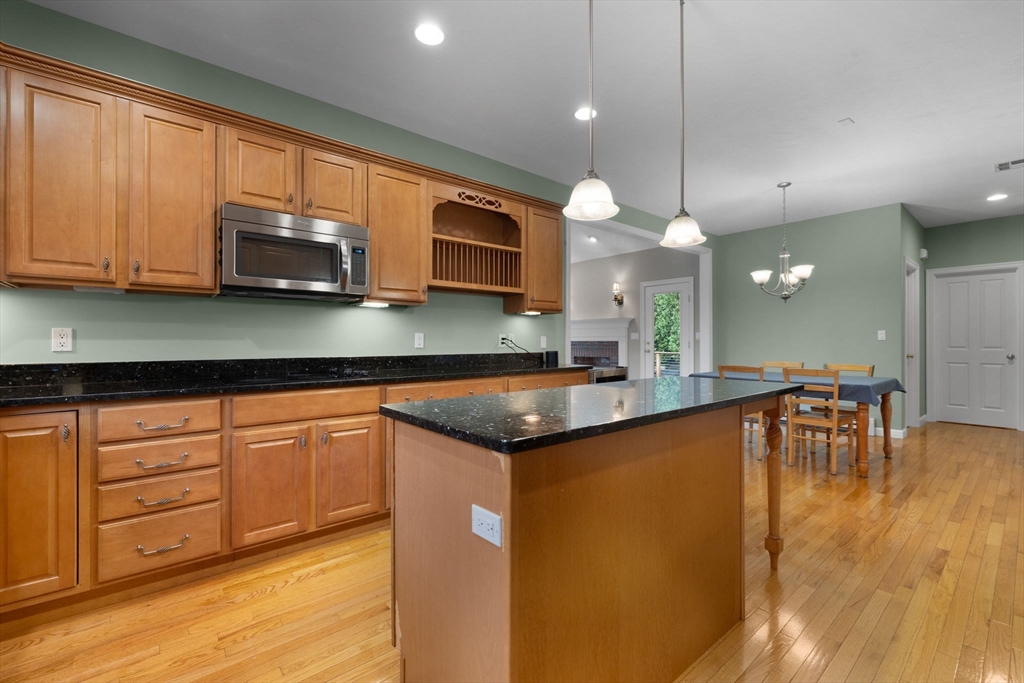 731 Samuel Drive Northbridge, MA 01588 - Photo 6 of 33 a kitchen with stainless steel appliances granite countertop a sink a stove top oven a counter space and cabinets