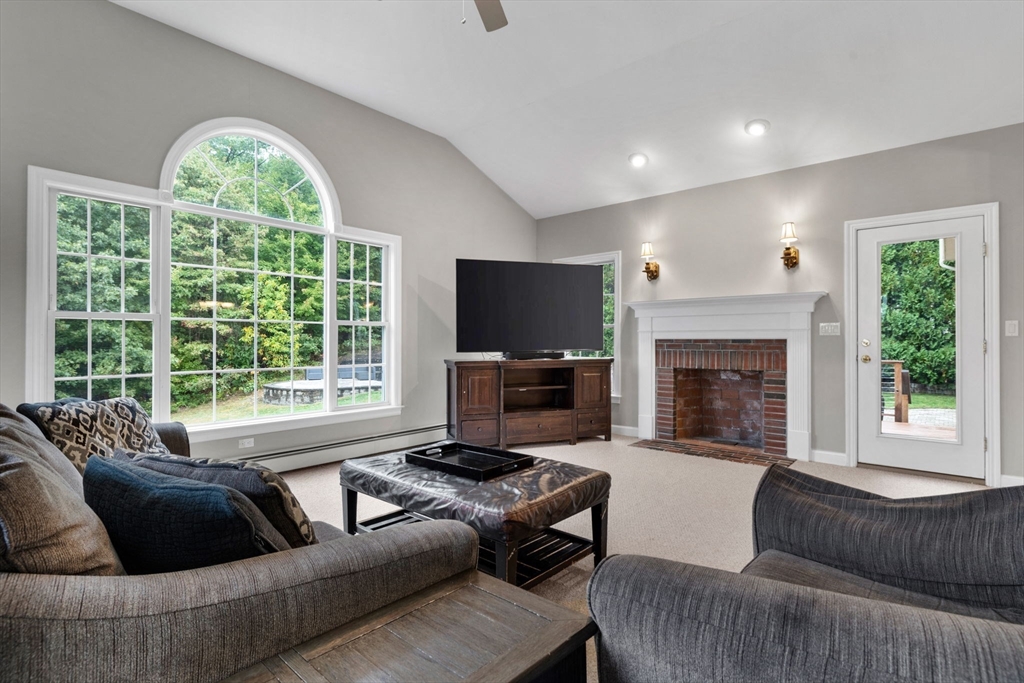 731 Samuel Drive Northbridge, MA 01588 - Photo 7 of 33 a living room with furniture a large window and a fireplace
