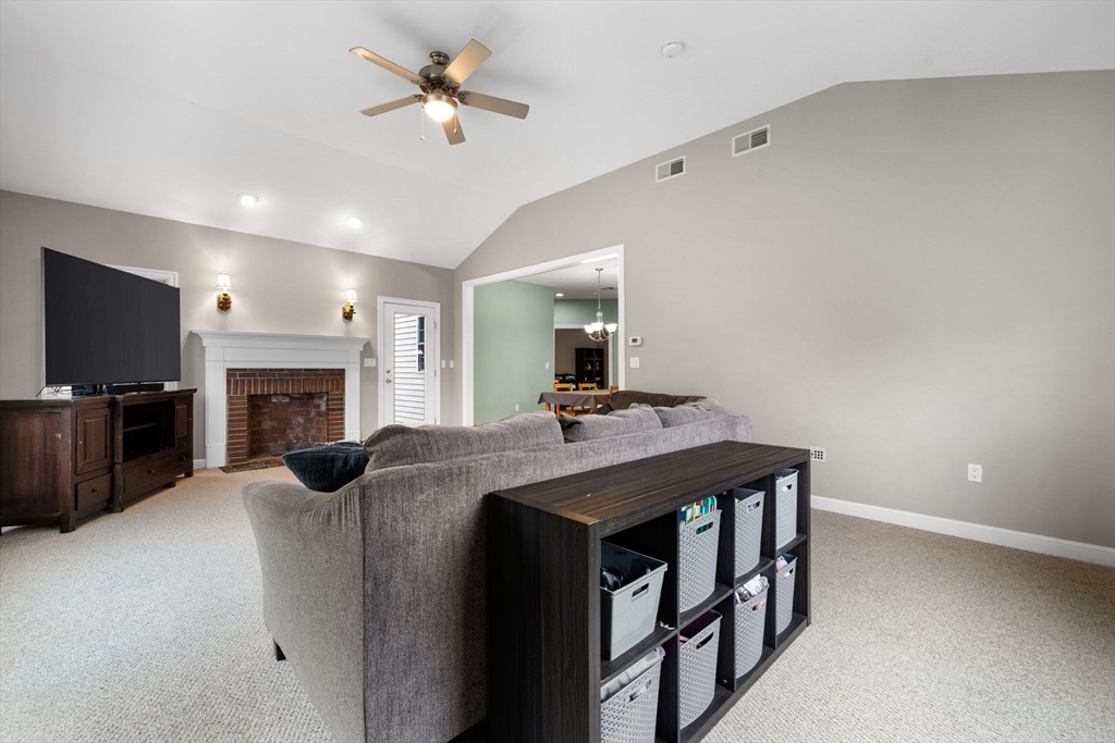 731 Samuel Drive Northbridge, MA 01588 - Photo 9 of 33 a living room with furniture a fireplace and a flat screen tv