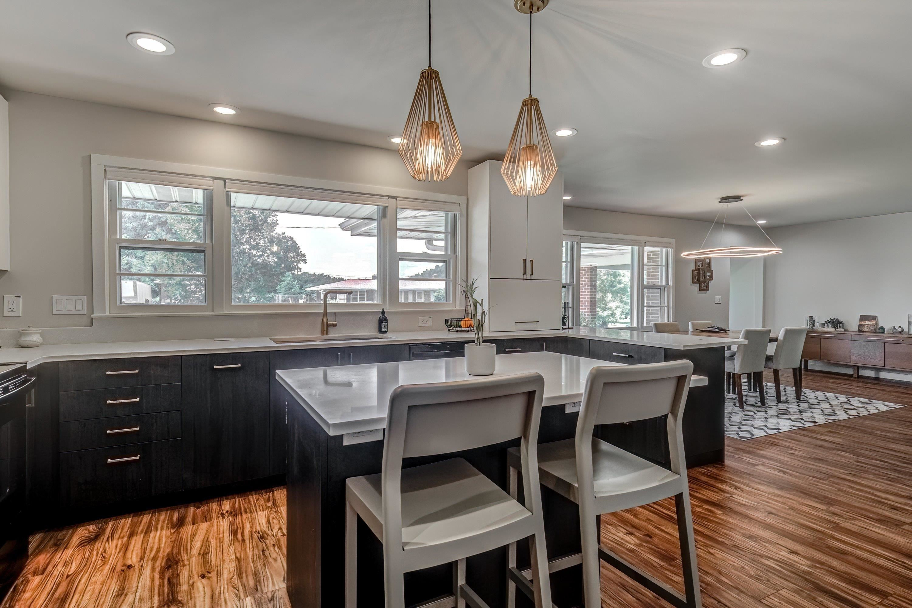 2405 Brenda Drive Raleigh, NC 27610 - Photo 13 of 27 a kitchen with stainless steel appliances granite countertop wooden floor dining table and chairs
