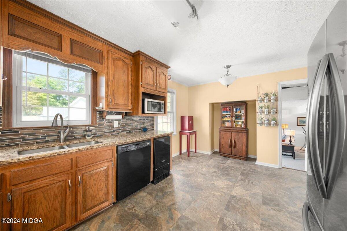 3645 Tidwell Road Lizella, GA 31052 - Photo 12 of 26 a large kitchen with stainless steel appliances granite countertop a refrigerator a sink and a stove
