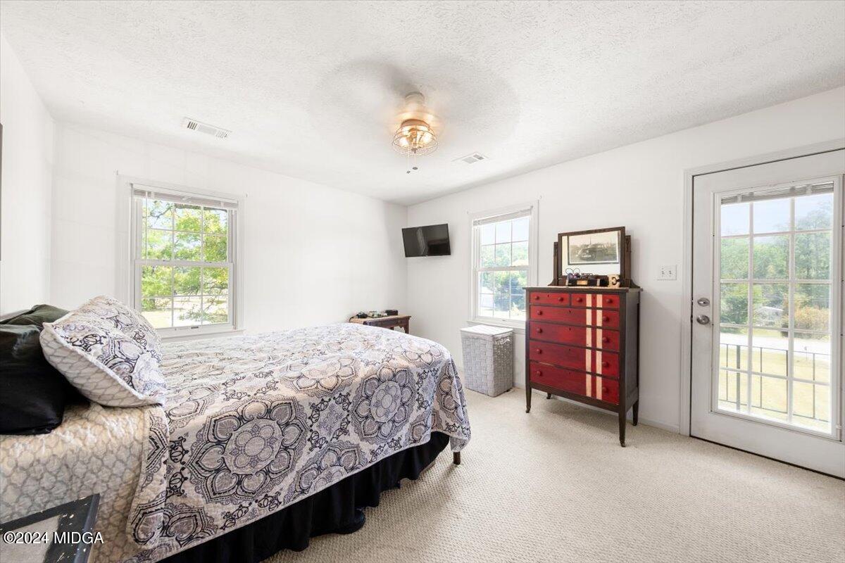 3645 Tidwell Road Lizella, GA 31052 - Photo 14 of 26 a bedroom with a bed dresser and a window