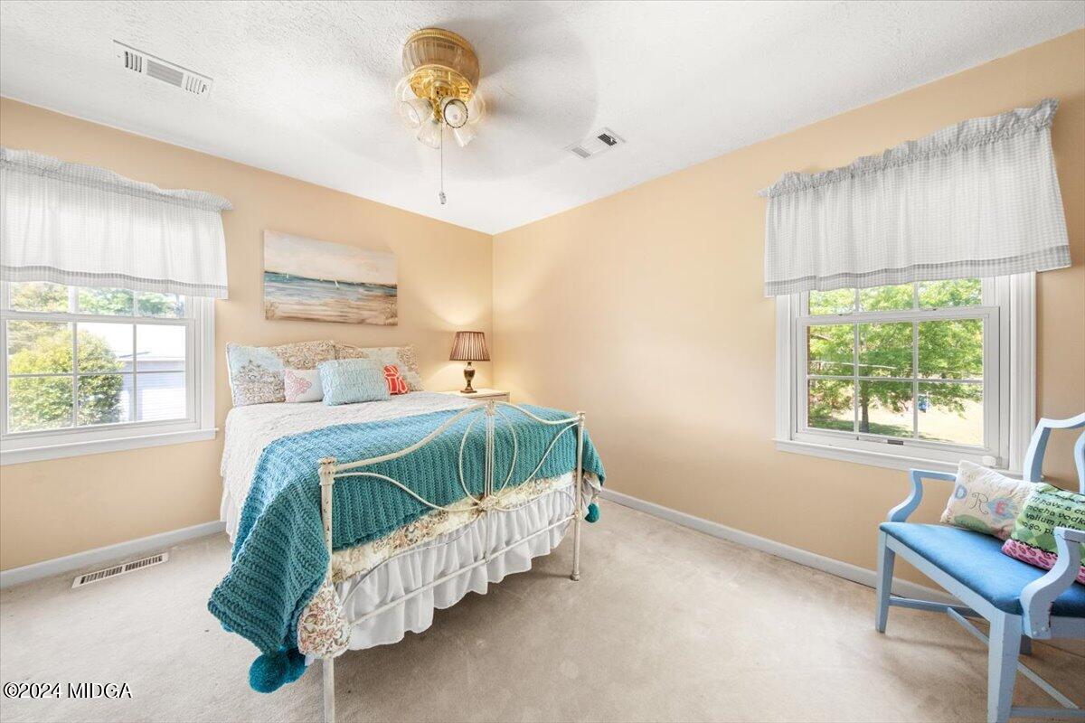 3645 Tidwell Road Lizella, GA 31052 - Photo 15 of 26 a bedroom with bed baby crib and a window