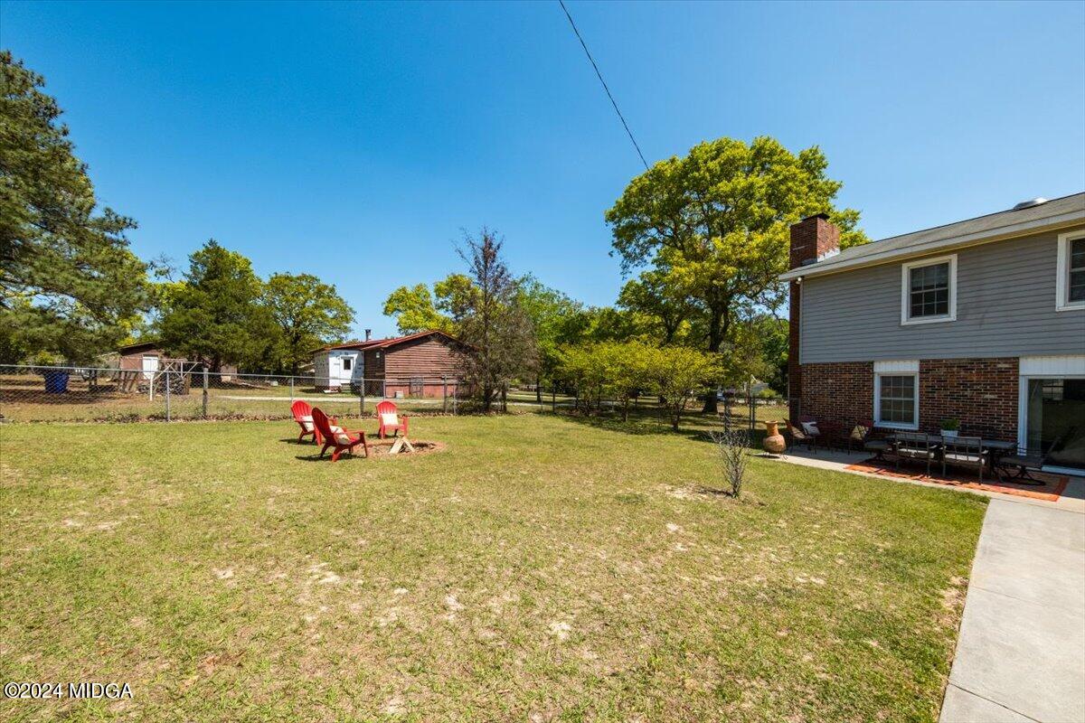 3645 Tidwell Road Lizella, GA 31052 - Photo 23 of 26 a view of a swimming pool with a slide and a small yard