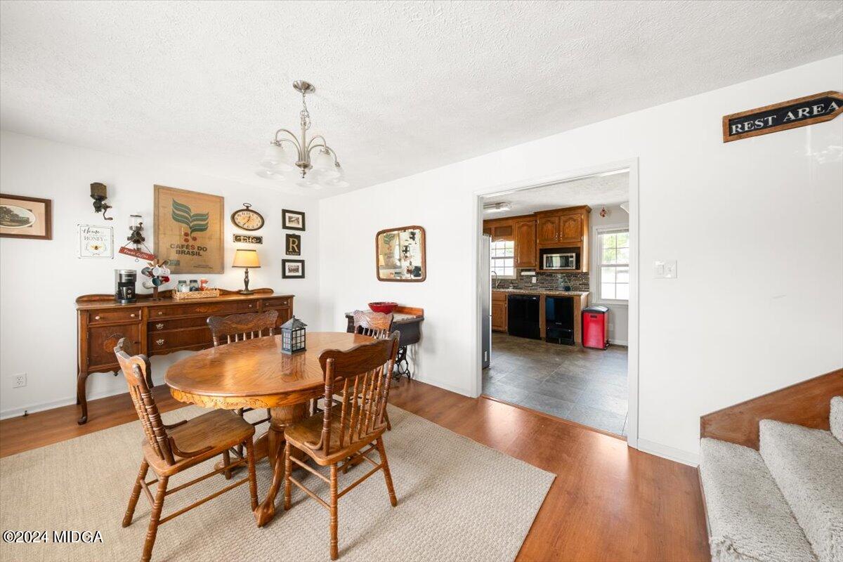 3645 Tidwell Road Lizella, GA 31052 - Photo 8 of 26 a view of a dining room with furniture and wooden floor