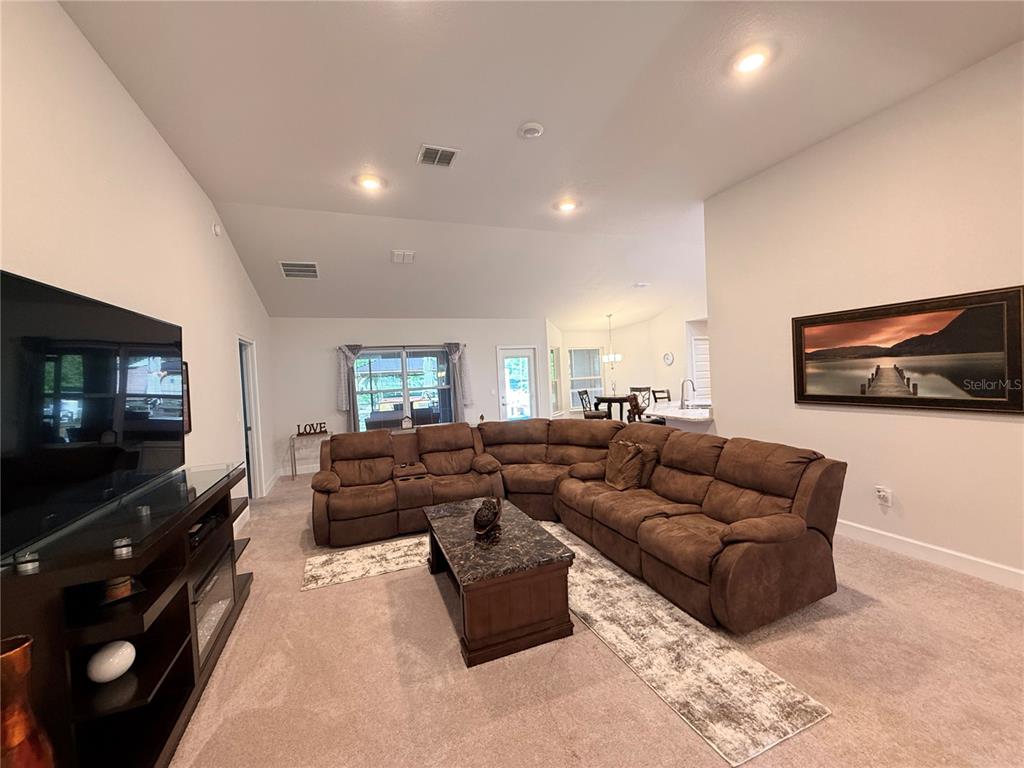 9832 Southwest 46th Court Ocala, FL 34476 - Photo 14 of 53 a living room with furniture and a flat screen tv