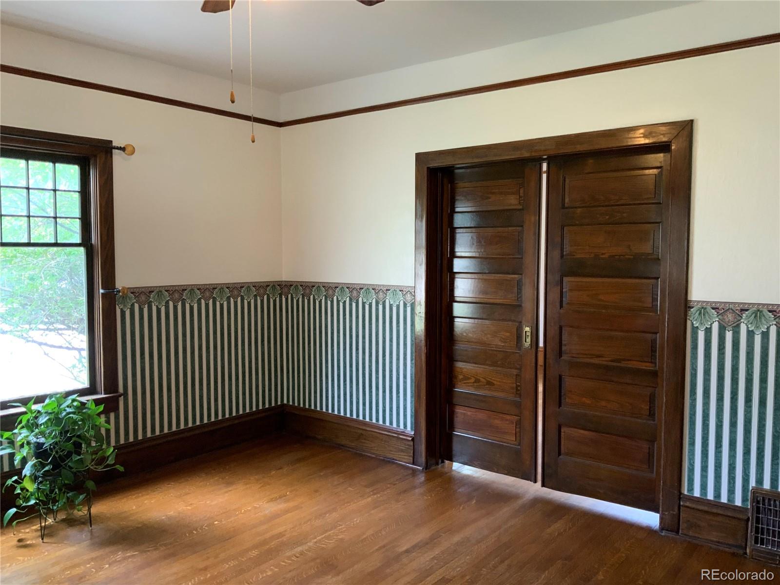 1011 Main Street Meeker, CO 81641 - Photo 19 of 28 an empty room with wooden floor and windows