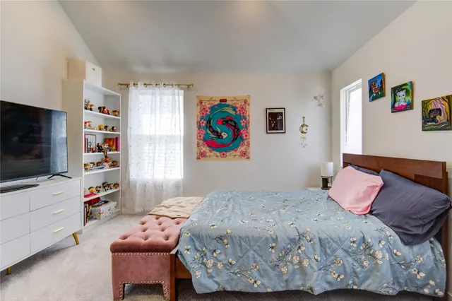a bedroom with a bed and flat screen tv