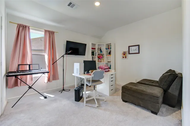 a living room with furniture and a bookshelf
