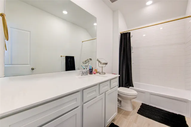a living room with furniture a flat screen tv and a window