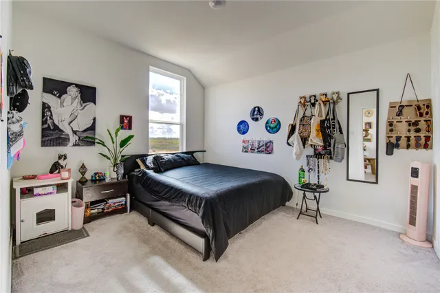 a dining room with a wooden table and chairs