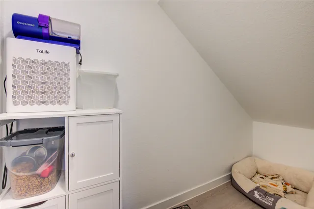 a room with stainless steel appliances kitchen island a table and chairs in it