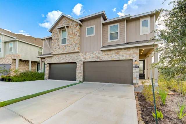 a view of a brick house with a small yard and wooden floor and fence