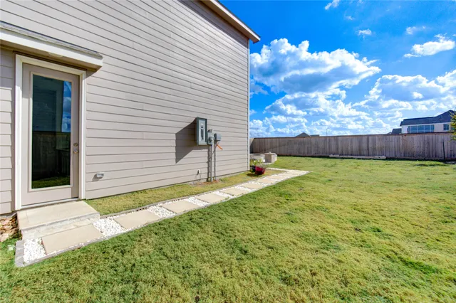 a view of a yard with a swimming pool