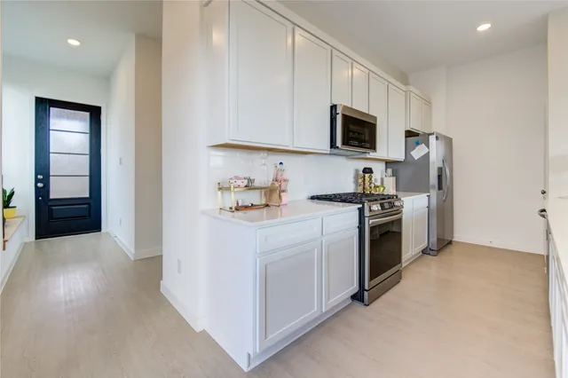 a kitchen with cabinets a sink and appliances