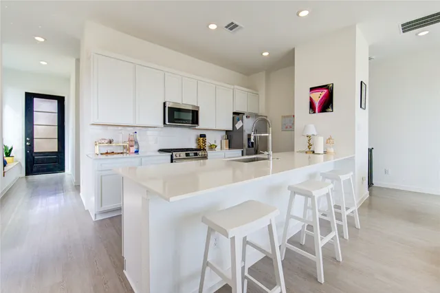 a kitchen with counter space dining table and chairs