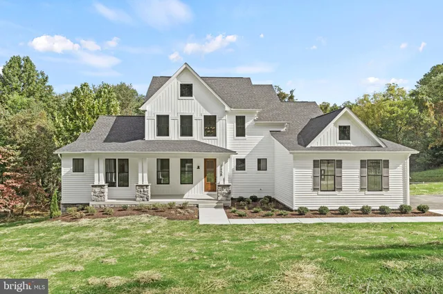 a front view of a house with a garden and yard