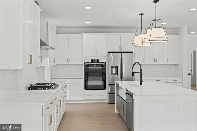 a kitchen with sink a refrigerator and a stove