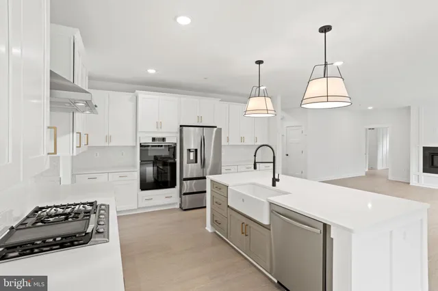 a view of a kitchen with a sink stainless steel appliances and cabinets