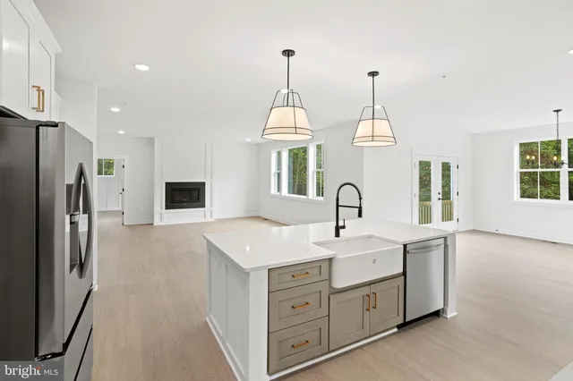 a kitchen with stainless steel appliances a refrigerator sink and microwave