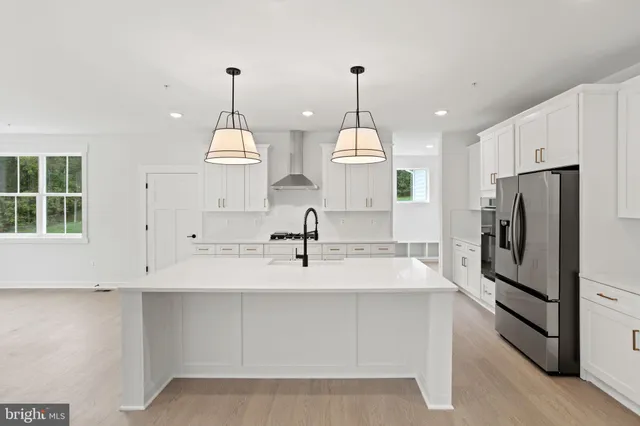 a kitchen with stainless steel appliances granite countertop a stove a sink dishwasher and a refrigerator