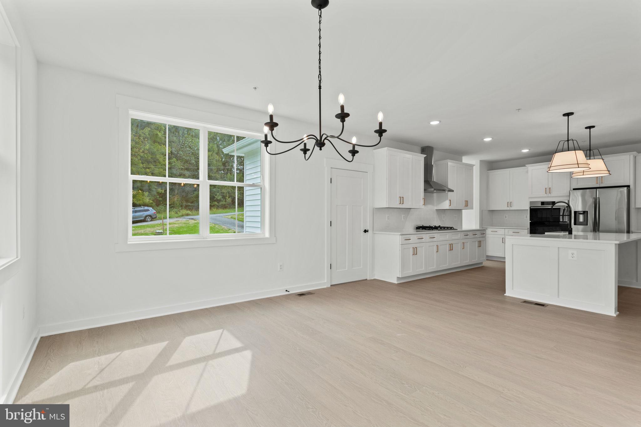 640 Grim Road Stephens City, VA 22655 - Photo 20 of 50 a view of a kitchen with a stove cabinets a ceiling fan and wooden floor