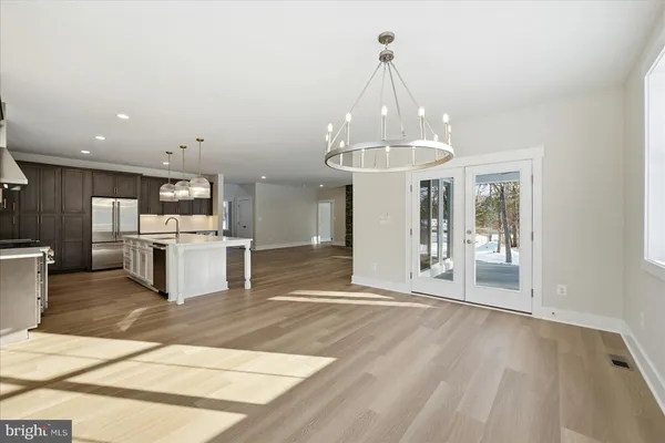 a view of a kitchen with cabinets and stainless steel appliances
