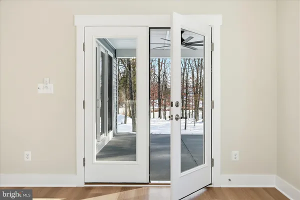 a view of a hallway with wooden floor