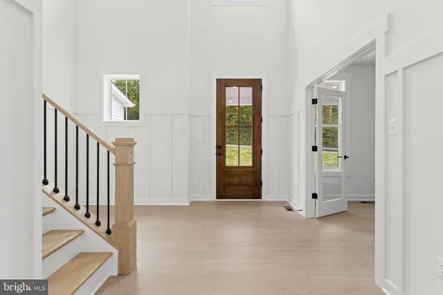 a view of entryway with wooden floor and stairs