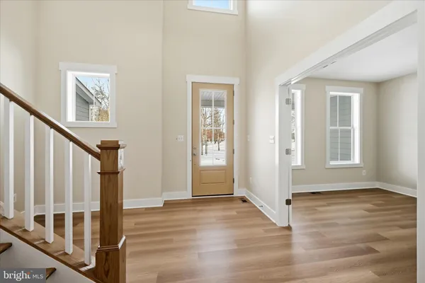 a view of an entryway with wooden floor and door
