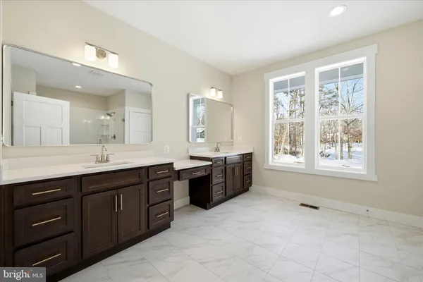 a spacious bathroom with a double vanity sink mirror and a bathtub