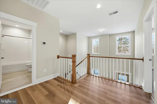 a view of an empty room with wooden floor
