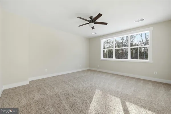 a view of a livingroom with a ceiling fan and window