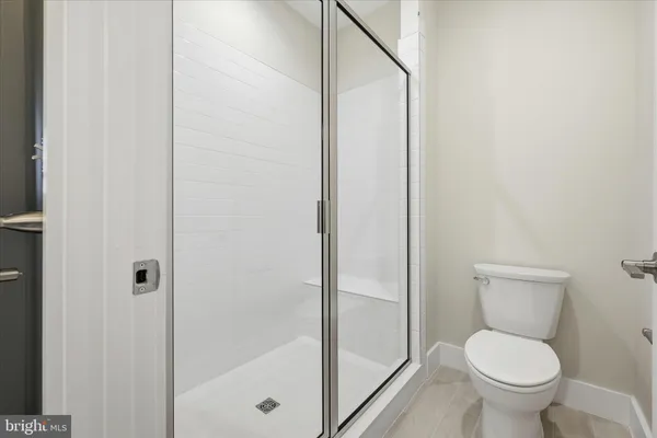 a a bathroom view of a toilet and a shower