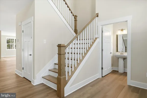 a view of entryway with wooden floor and stairs