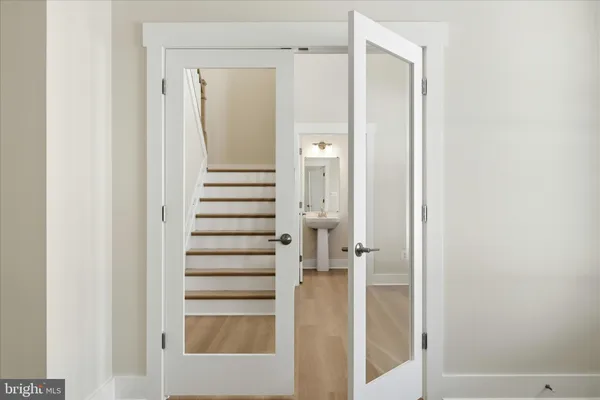 a view of a bathroom with a white door and a shower