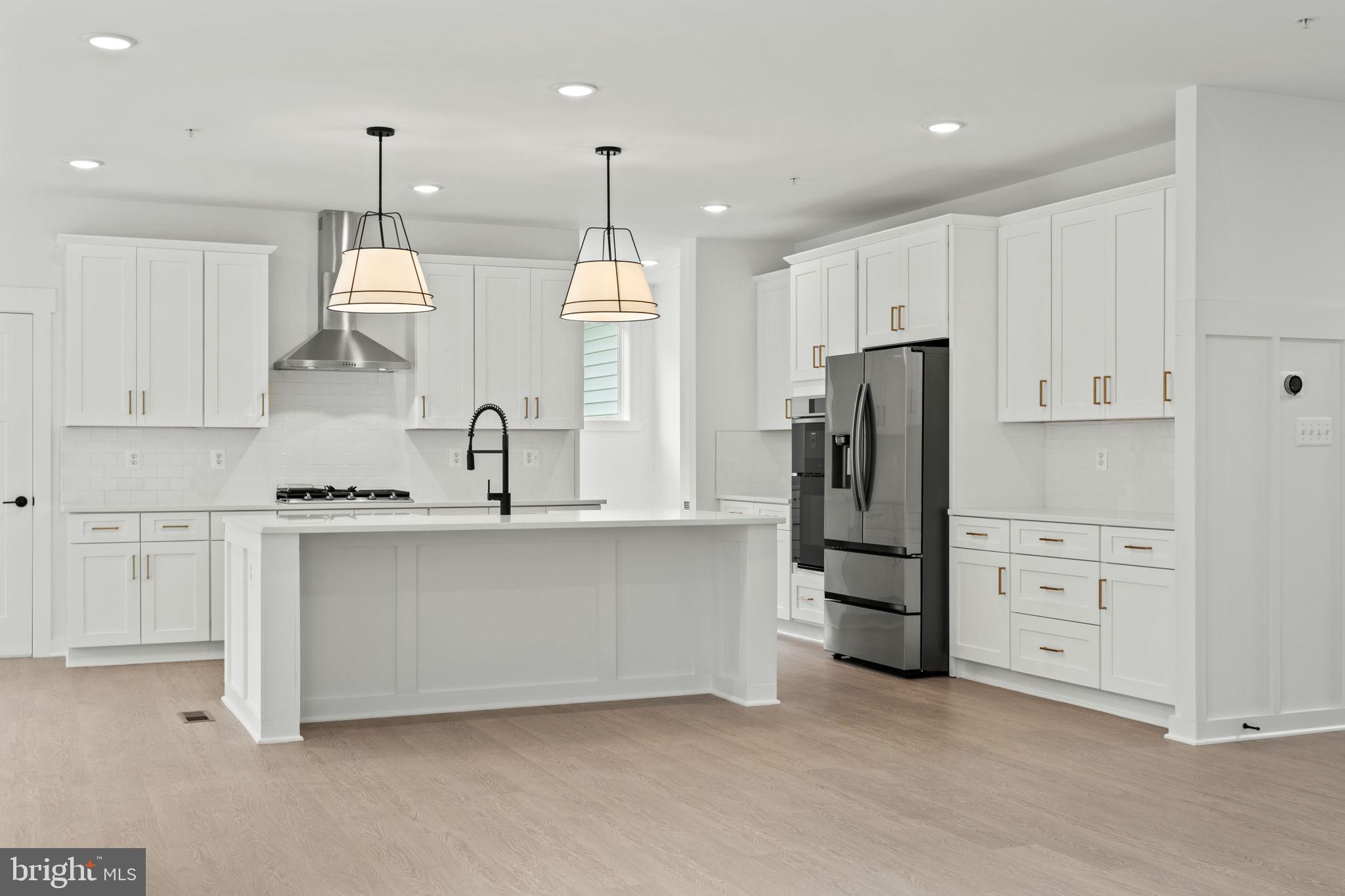 640 Grim Road Stephens City, VA 22655 - Photo 10 of 50 a kitchen with white cabinets and stainless steel appliances