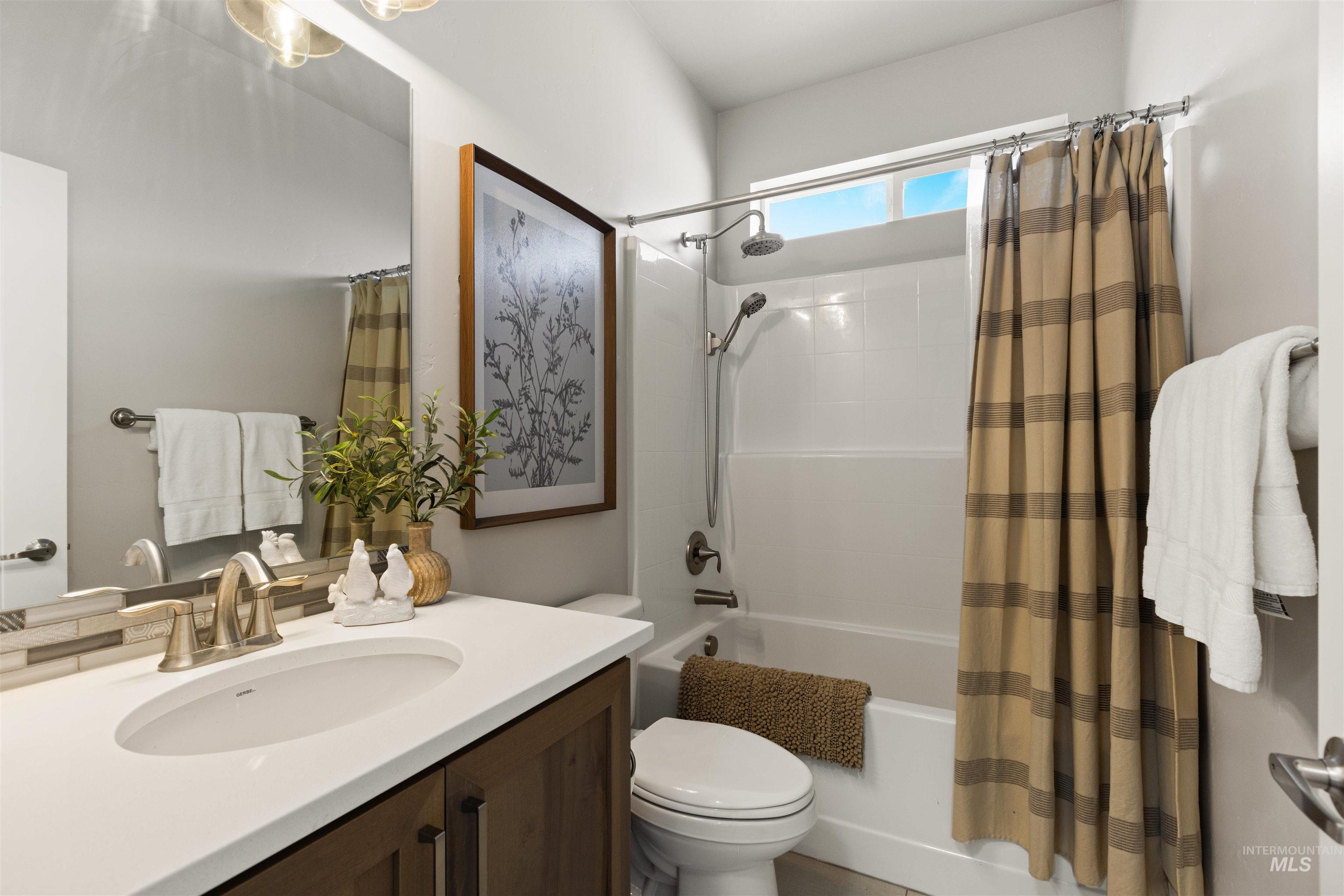 4551 South Lava Springs Loop Nampa, ID 83686 - Photo 12 of 49 Bathroom featuring vanity and shower / bathtub combination with curtain
