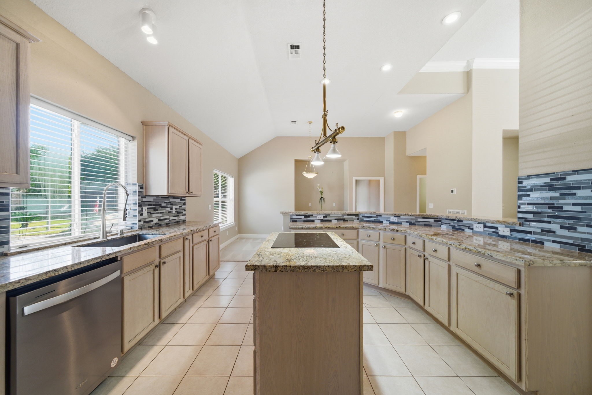 19803 Excalibur Court Houston, TX 77094 - Photo 18 of 34 a large kitchen with a sink and cabinets