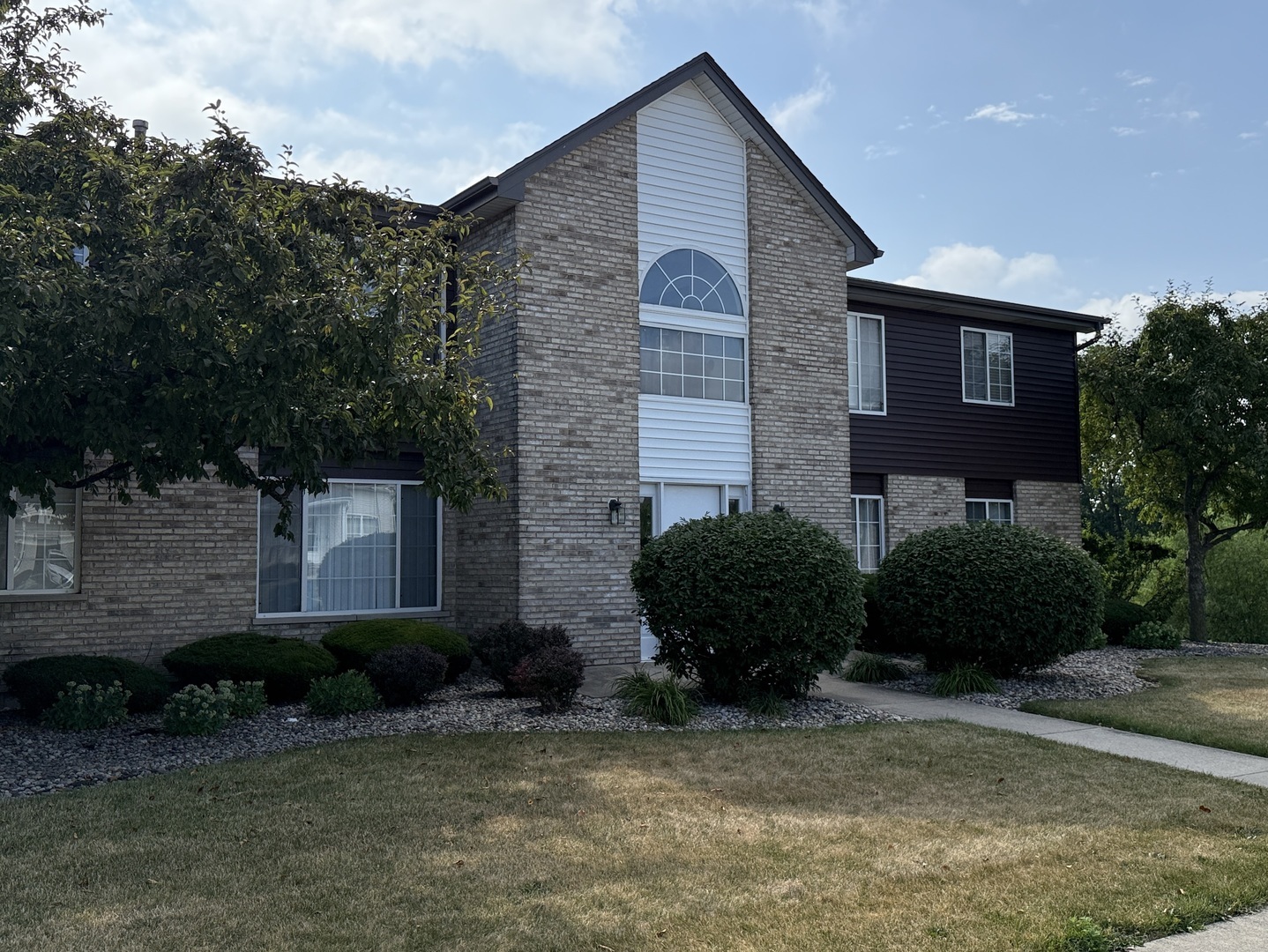 1411 Berta Drive, Unit 2N Crest Hill, IL 60403 - Photo 1 of 20 a view of a brick house with a yard and plants