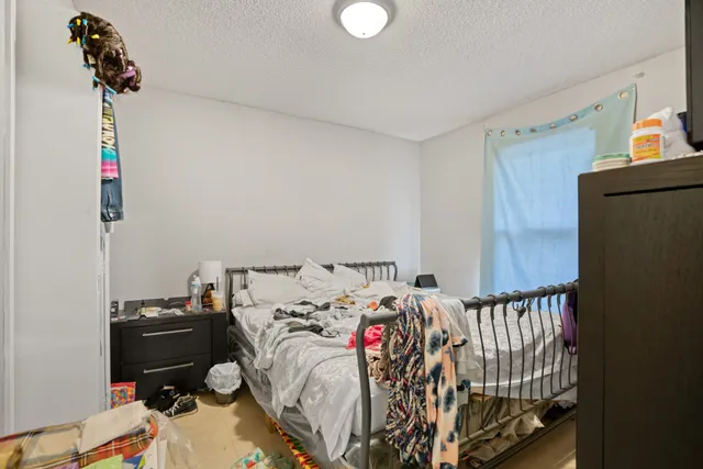 a front view of house with yard and trees in the background