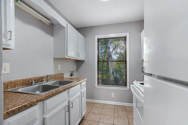 a kitchen with a sink cabinets and window