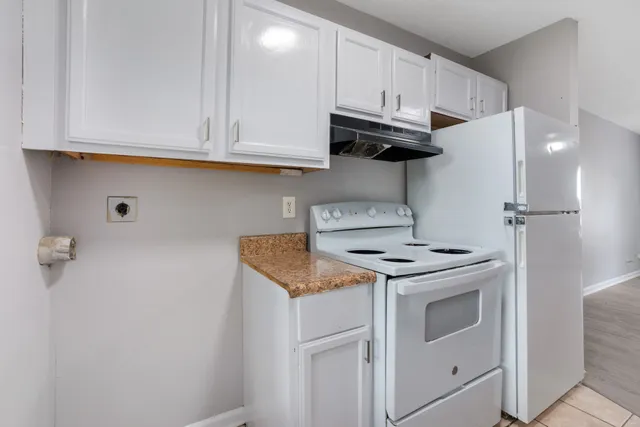 a kitchen with stainless steel appliances granite countertop a stove a refrigerator and a microwave