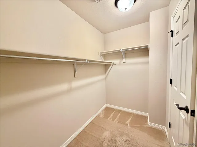 a view of walk in closet with empty racks