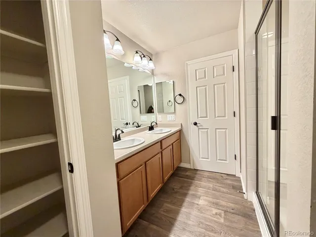 a bathroom with a double vanity sink and mirror