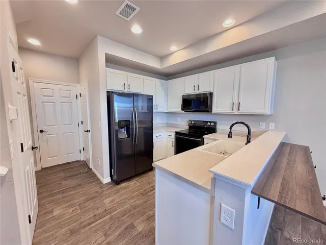 a kitchen with a refrigerator and a sink