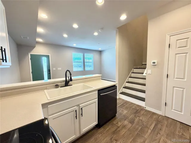 a view of a kitchen with sink and dishwasher